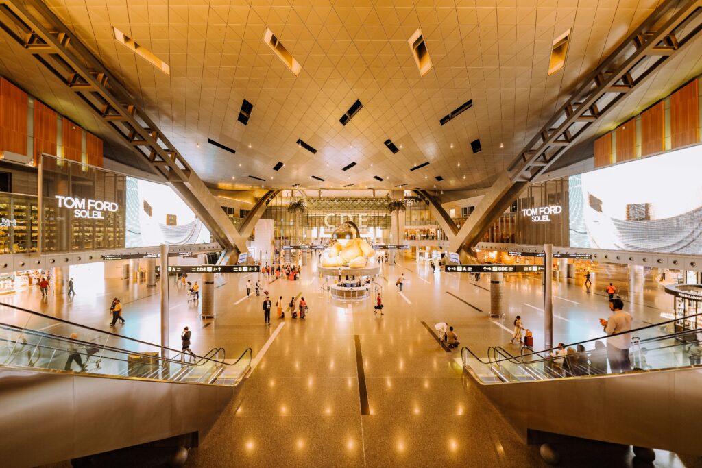 pexels-photo-2610756-2610756 View of a spacious modern terminal interior with travelers and architectural features.